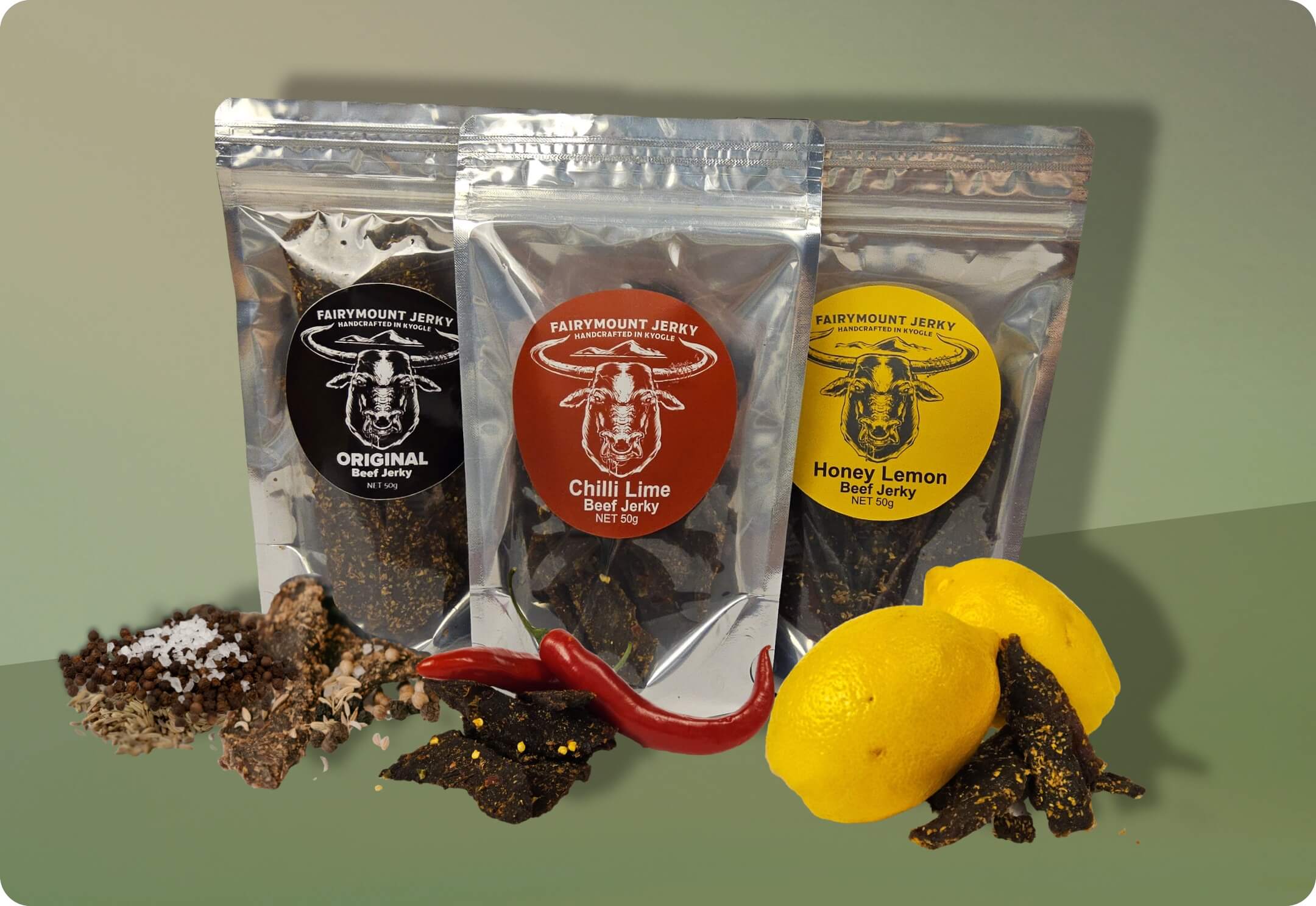 The Fairymount Beef Jerky Taster Pack in a Green Box Setting with all Ingredients